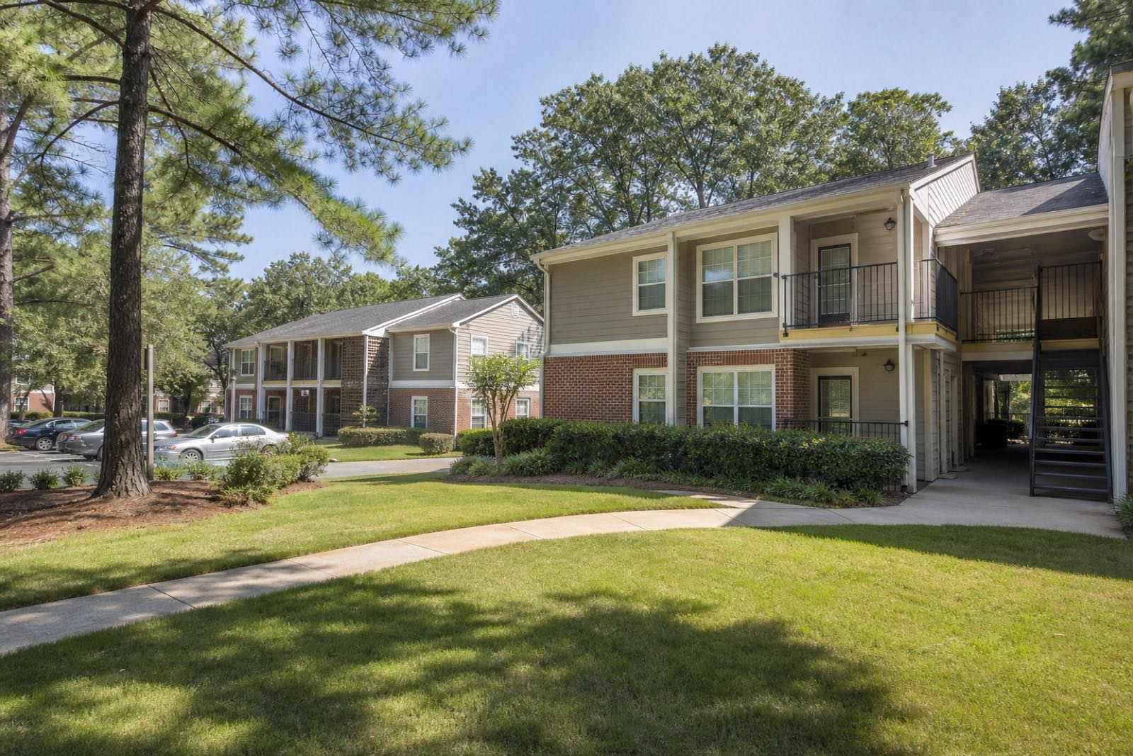 Garden-style apartment community in Decatur with mature trees and brick walkways